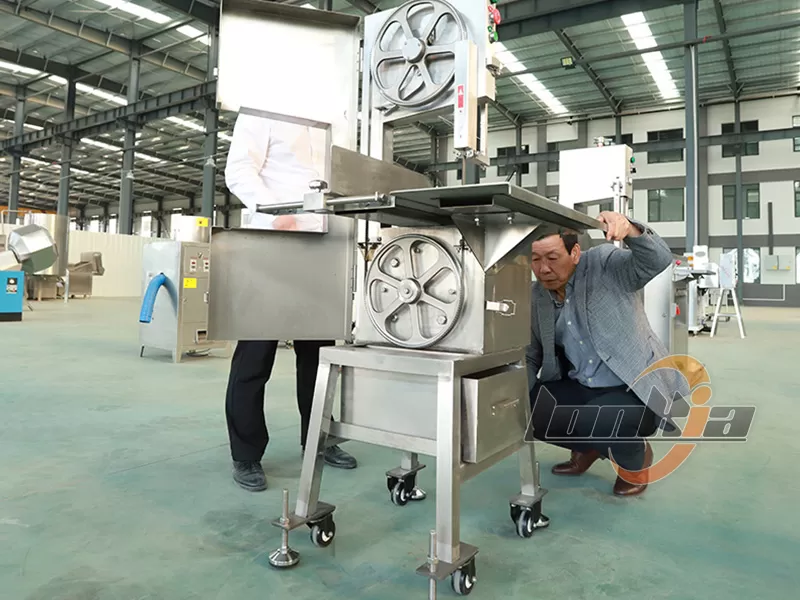 Customer operates bone saw machine